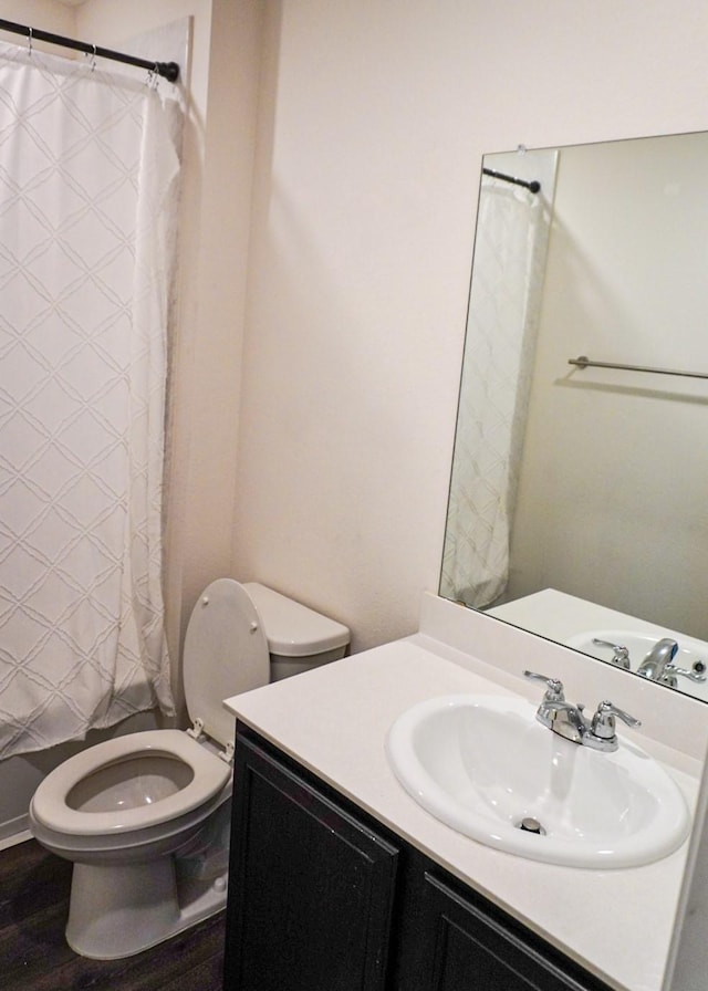 3128 Bettin Dr, Mesquite, TX 75126 - bathroom with toilet, vanity, a shower with shower curtain, and wood finished floors