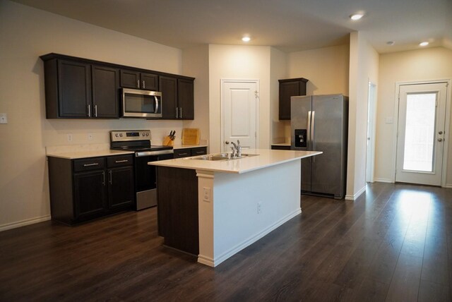 3128 Bettin Dr, Mesquite, TX 75126 - kitchen featuring stainless steel appliances, a sink, dark wood finished floors, light countertops, and a kitchen island with sink