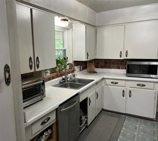 1224 Bellaire Dr, Grapevine, TX 76051 - kitchen with appliances with stainless steel finishes, a sink, white cabinets, and light countertops