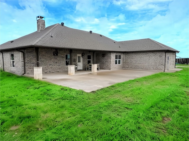 1061 N Whitt Rd, Perrin, TX 76486 - rear view of house featuring a patio area, a chimney, brick siding, and a lawn
