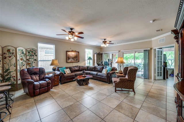 1628 Overwood Dr, Frisco, TX 75036 - living area with ornamental molding, ceiling fan, plenty of natural light, light tile patterned floors, and a textured ceiling