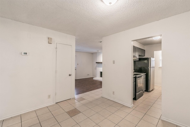 6188 Vega Dr, Fort Worth, TX 76133 - spare room with a textured ceiling, baseboards, and light tile patterned flooring