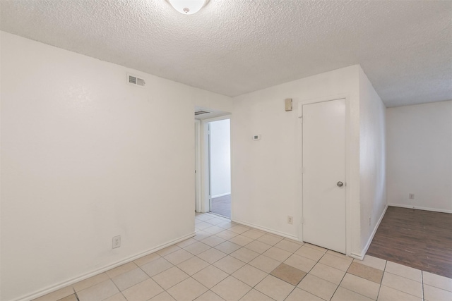 6188 Vega Dr, Fort Worth, TX 76133 - unfurnished room with a textured ceiling, light tile patterned floors, and baseboards