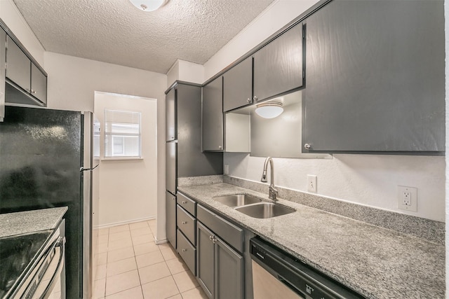 6188 Vega Dr, Fort Worth, TX 76133 - kitchen with a sink, light tile patterned floors, stainless steel appliances, a textured ceiling, and baseboards