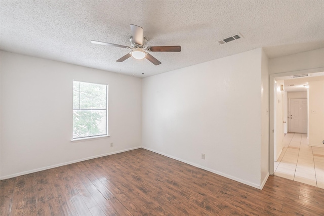 6188 Vega Dr, Fort Worth, TX 76133 - empty room featuring wood finished floors, ceiling fan, baseboards, and a textured ceiling