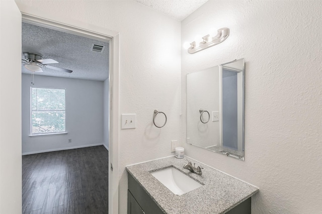 6188 Vega Dr, Fort Worth, TX 76133 - bathroom featuring a textured ceiling, a ceiling fan, vanity, and wood finished floors