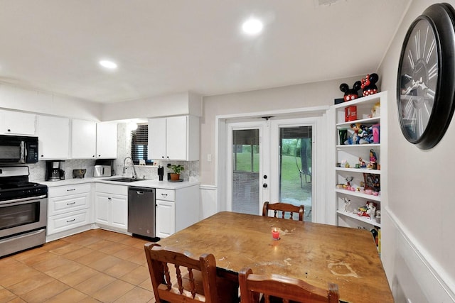 2422 Sue Cir, Mesquite, TX 75149 - kitchen with appliances with stainless steel finishes, light countertops, white cabinets, tasteful backsplash, and recessed lighting