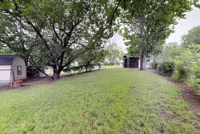 2422 Sue Cir, Mesquite, TX 75149 - fenced backyard with a storage unit