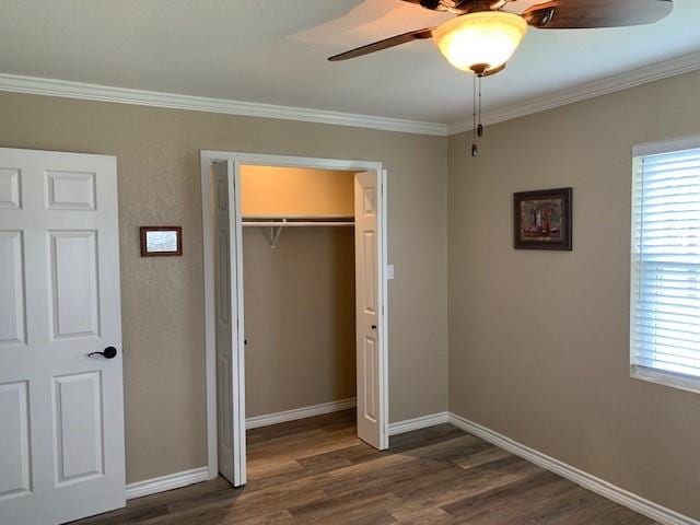222 County Road 2195, Decatur, TX 76234 - unfurnished bedroom with ornamental molding, dark wood finished floors, multiple windows, a closet, and baseboards