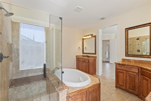 bathroom with tiled shower, a bath, and plenty of natural light