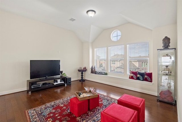 living area featuring wood finished floors, baseboards, and lofted ceiling