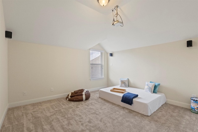 bedroom featuring lofted ceiling, carpet flooring, and baseboards