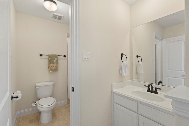 bathroom with toilet, vanity, tile patterned floors, and baseboards