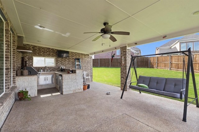 view of patio / terrace featuring area for grilling, a sink, and a ceiling fan
