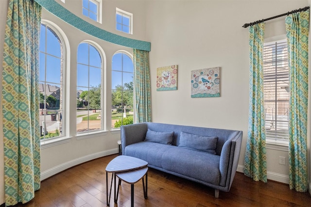 sitting room with hardwood / wood-style floors and baseboards