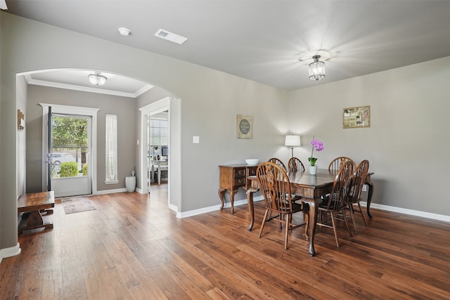 1844 Sweet Gum Dr, Anna, TX 75409 - dining space with arched walkways, hardwood / wood-style floors, baseboards, and ornamental molding