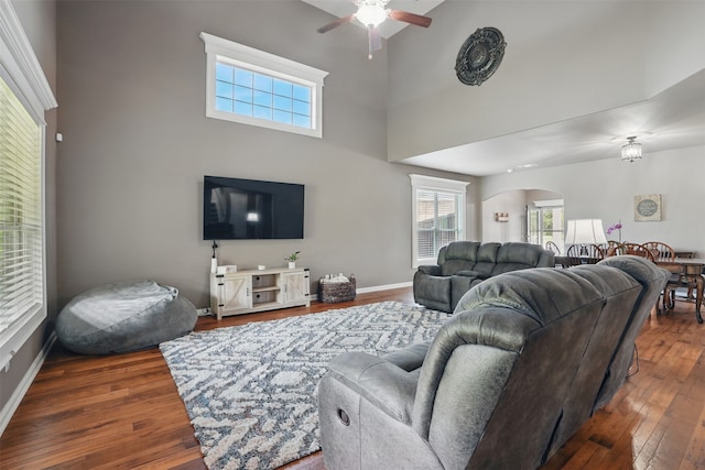 1844 Sweet Gum Dr, Anna, TX 75409 - living area with arched walkways, a ceiling fan, a towering ceiling, wood finished floors, and baseboards