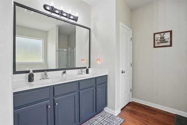1844 Sweet Gum Dr, Anna, TX 75409 - bathroom with wood finished floors, an enclosed shower, baseboards, and double vanity