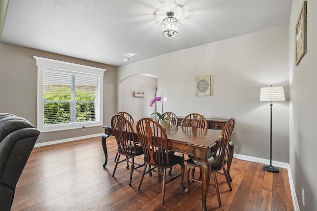 1844 Sweet Gum Dr, Anna, TX 75409 - dining space featuring baseboards, arched walkways, and hardwood / wood-style flooring