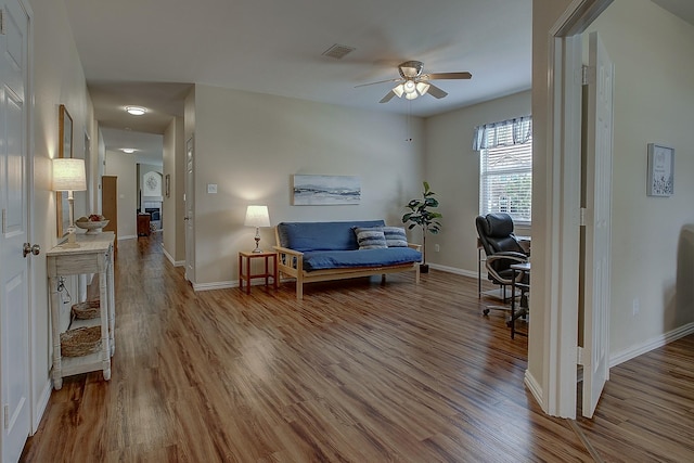 1300 Shelby Ct, Wylie, TX 75098 - living area featuring a ceiling fan, wood finished floors, and baseboards