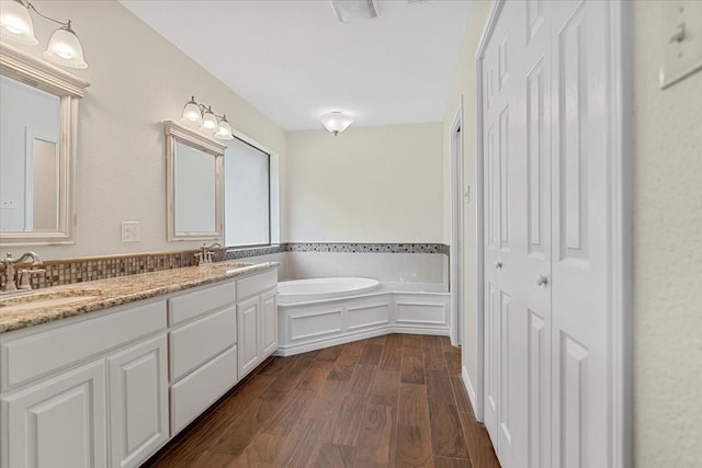 1717 Adams Ln, Azle, TX 76020 - full bathroom with wood finished floors, a bath, and double vanity