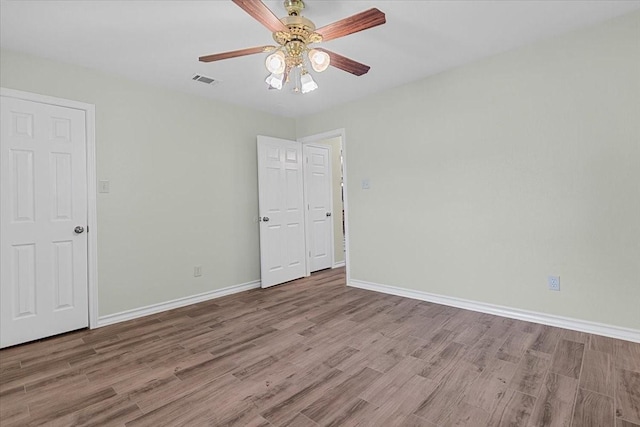 1717 Adams Ln, Azle, TX 76020 - spare room with wood finished floors, a ceiling fan, and baseboards
