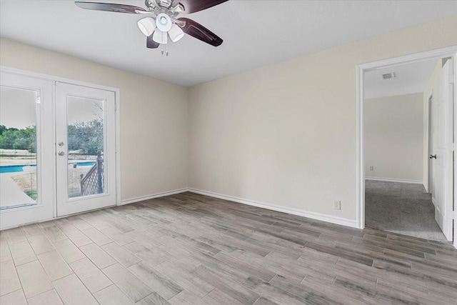 1717 Adams Ln, Azle, TX 76020 - spare room featuring ceiling fan, french doors, wood finished floors, and baseboards