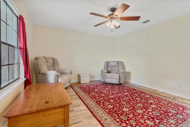 1717 Adams Ln, Azle, TX 76020 - living area with wood finished floors, a ceiling fan, and baseboards