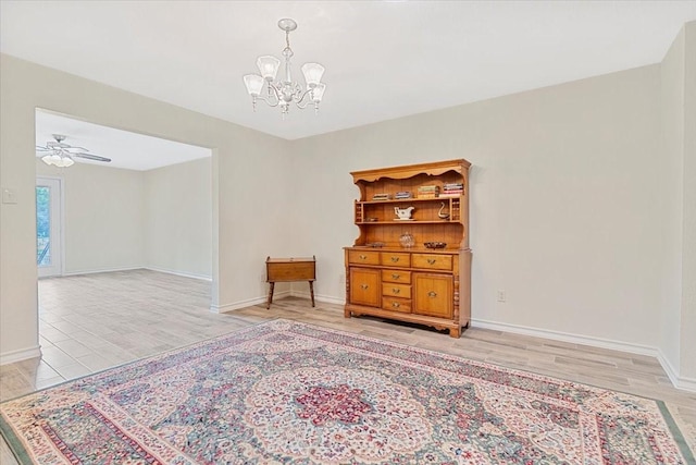 1717 Adams Ln, Azle, TX 76020 - empty room with a chandelier, light wood-style flooring, baseboards, and ceiling fan