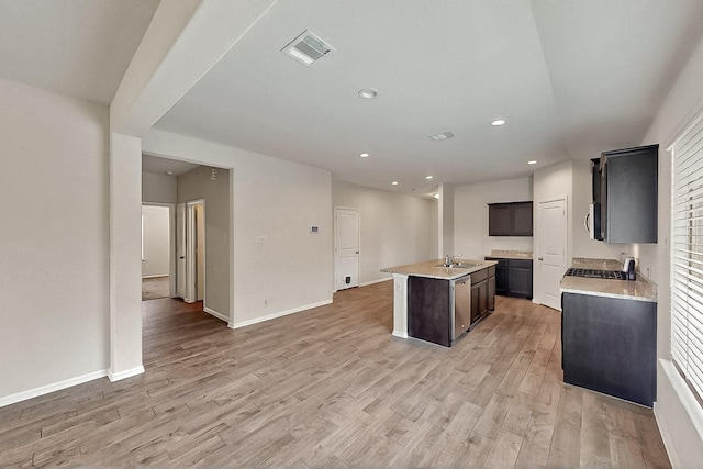 4612 Corktree Ln, Fort Worth, TX 76036 - kitchen featuring a kitchen island with sink, light wood finished floors, a sink, open floor plan, and recessed lighting