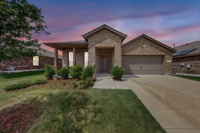 4612 Corktree Ln, Fort Worth, TX 76036 - view of front of property with driveway, a garage, a front yard, brick siding, and stone siding