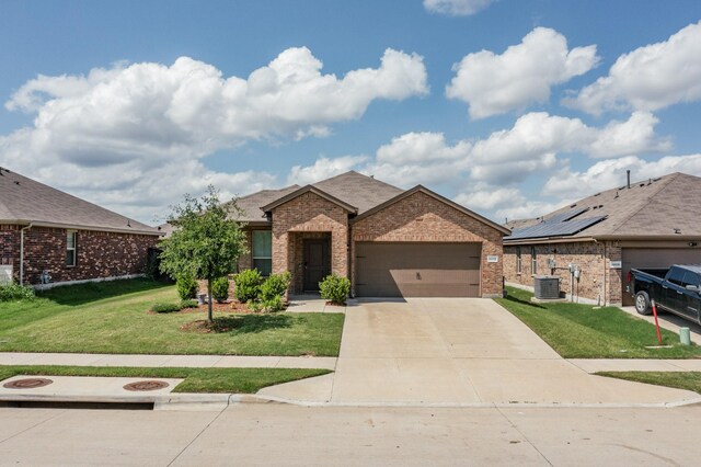 4612 Corktree Ln, Fort Worth, TX 76036 - view of front facade featuring central AC, brick siding, a garage, driveway, and a front lawn