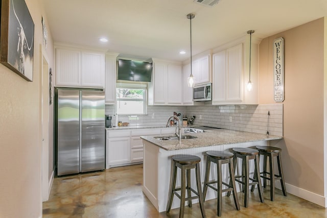 505 Advance Rd, Weatherford, TX 76088 - kitchen with appliances with stainless steel finishes, a sink, a peninsula, tasteful backsplash, and white cabinetry