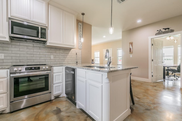 505 Advance Rd, Weatherford, TX 76088 - kitchen featuring stainless steel appliances, a sink, a peninsula, backsplash, and plenty of natural light