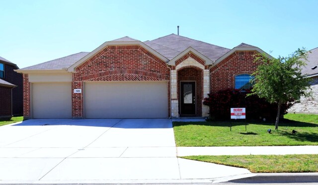 1129 Cropout Way, Fort Worth, TX 76052 - view of front of home featuring a garage, brick siding, driveway, and a front yard