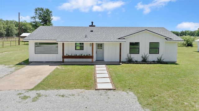 698 County Road 3825, Bridgeport, TX 76458 - modern farmhouse style home with board and batten siding, roof with shingles, covered porch, and driveway