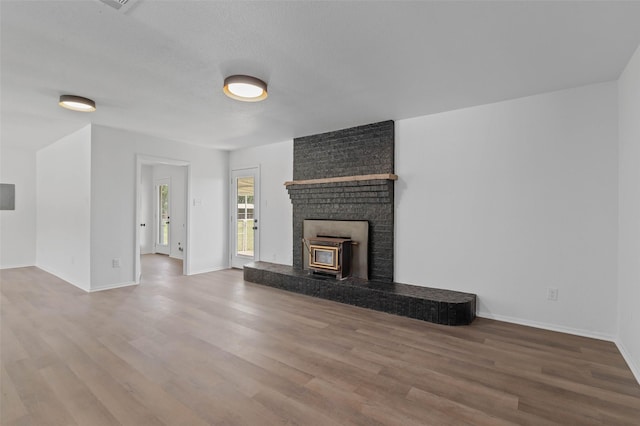 698 County Road 3825, Bridgeport, TX 76458 - unfurnished living room with wood finished floors, baseboards, and a fireplace