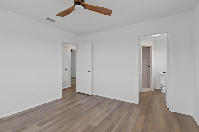 698 County Road 3825, Bridgeport, TX 76458 - unfurnished bedroom with wood finished floors, baseboards, and connected bathroom