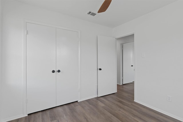 698 County Road 3825, Bridgeport, TX 76458 - unfurnished bedroom featuring wood finished floors, a closet, baseboards, and a ceiling fan