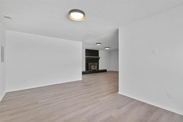 698 County Road 3825, Bridgeport, TX 76458 - spare room with a fireplace, wood finished floors, and baseboards