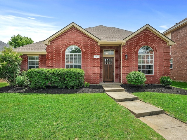 5917 Dark Forest Dr, Mckinney, TX 75070 - ranch-style home with brick siding, a front yard, and roof with shingles