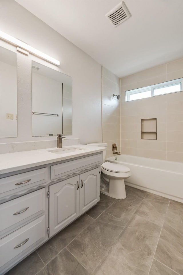 bathroom with shower / bath combination, vanity, and toilet