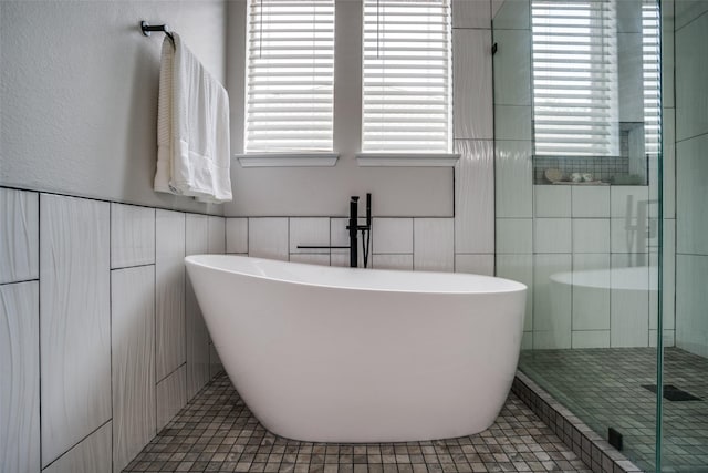 1312 Merrimac Dr, Allen, TX 75002 - full bathroom with tile walls, healthy amount of natural light, a stall shower, a freestanding tub, and tile patterned flooring