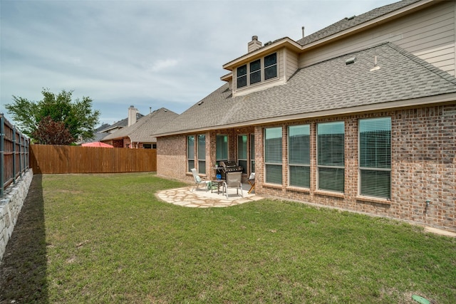 1312 Merrimac Dr, Allen, TX 75002 - back of house featuring brick siding, a patio area, a chimney, and a shingled roof
