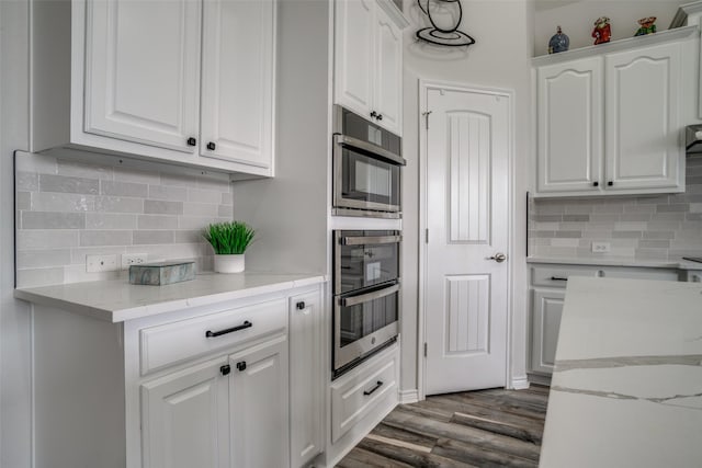 1312 Merrimac Dr, Allen, TX 75002 - kitchen featuring oven, white cabinets, and tasteful backsplash