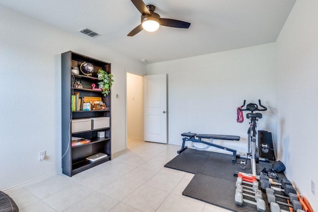 workout area with a ceiling fan and light tile patterned floors