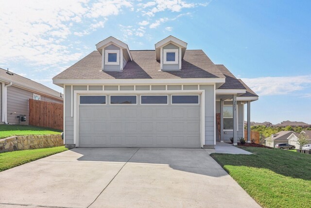 view of front of home with a garage, driveway, and a shingled roof