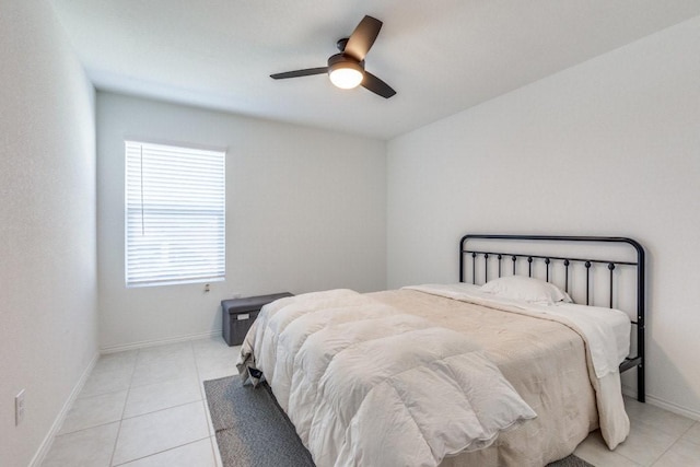 bedroom featuring light tile patterned flooring, a ceiling fan, and baseboards