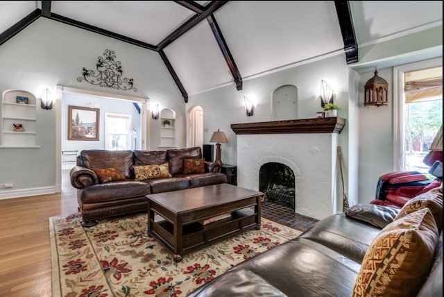 5202 Morningside Ave, Dallas, TX 75206 - living room with arched walkways, wood finished floors, beam ceiling, a fireplace, and baseboards