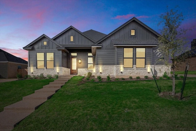 10201 Castleberry Ln, Waco, TX 76712 - view of front of house with board and batten siding, a front yard, and stone siding